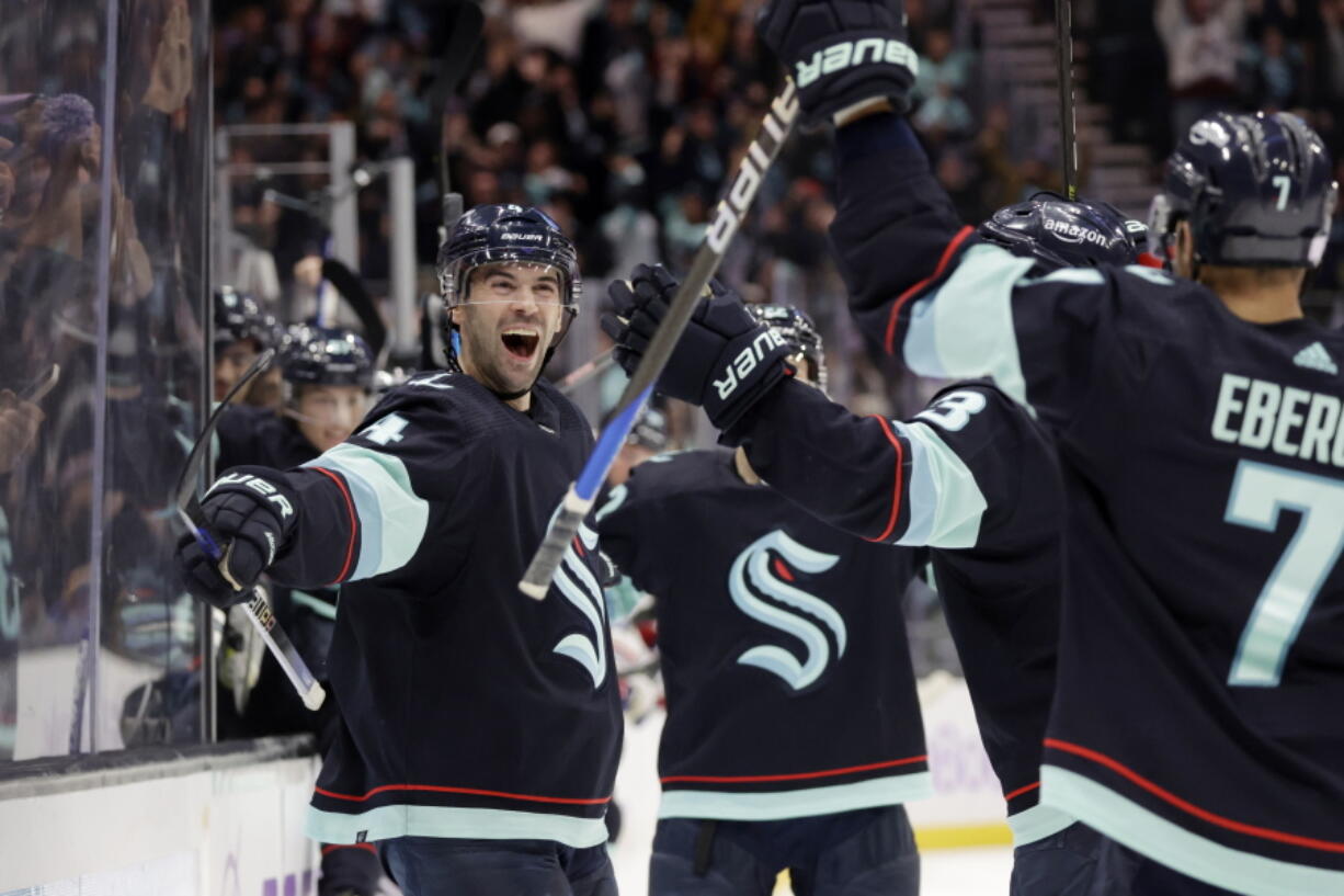 Seattle Kraken defenseman Justin Schultz (4) reacts after scoring in overtime against the New York Rangers during an NHL hockey game Thursday, Nov. 17, 2022, in Seattle.