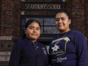 Lorena Ramirez stands with her daughter Citlalli outside St. Anthony School on Oct. 20 in Milwaukee.