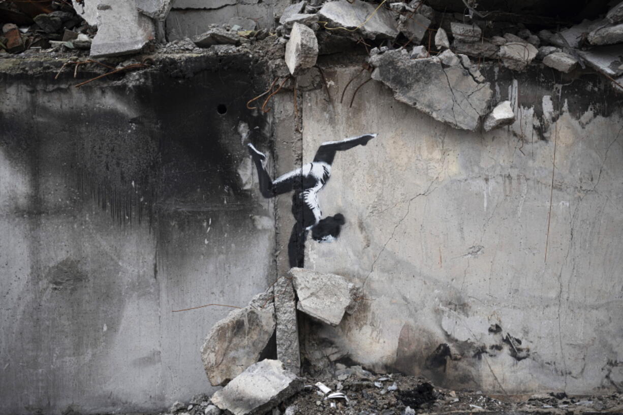 An artwork by British street artist Banksy is seen on a destroyed by fightings building in Borodyanka, Kyiv region, Ukraine, Sunday, Nov. 13, 2022.