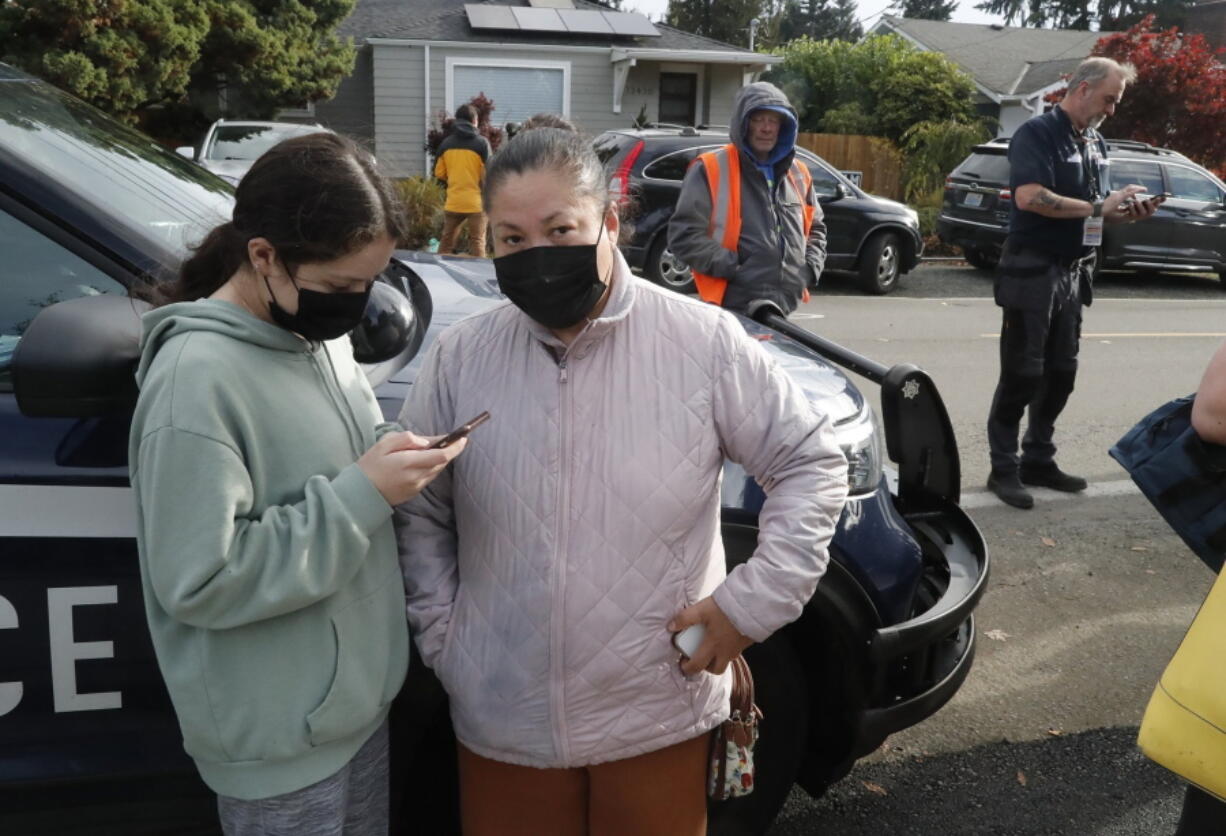 Anxious parents wait for word outside Ingraham High School after reports of a school shooting in Seattle, on Tuesday, Nov. 8, 2022. A student who was shot at the Seattle high school has died and a suspect is in custody, officials said.