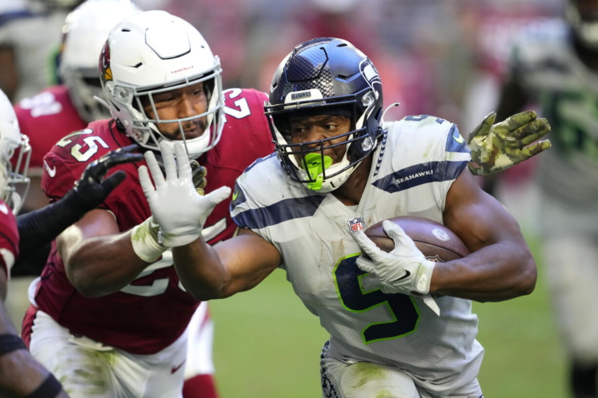 Seattle Seahawks running back Kenneth Walker III (9) runs against Arizona Cardinals linebacker Zaven Collins (25) during the second half of an NFL football game in Glendale, Ariz., Sunday, Nov. 6, 2022.