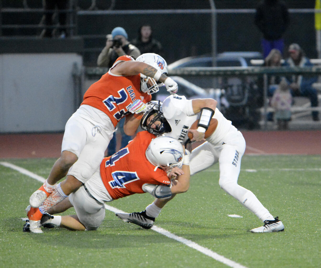 Graham-Kapowsin's Leuma Taylor-Pomele (23) and Jacob Bowen (44) sack Skyview quarterback Jake Kennedy  during the Storm's 42-28 loss to Graham-Kapowsin in a Class 4A state playoff game at Spanaway on Saturday, Nov. 12, 2022.