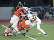 Graham-Kapowsin's Leuma Taylor-Pomele (23) and Jacob Bowen (44) sack Skyview quarterback Jake Kennedy  during the Storm's 42-28 loss to Graham-Kapowsin in a Class 4A state playoff game at Spanaway on Saturday, Nov. 12, 2022.