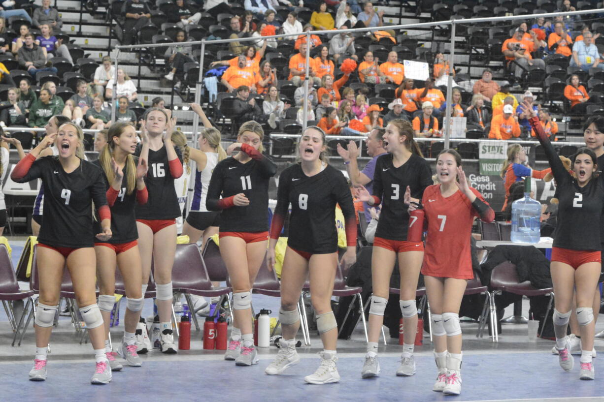 The Camas bench celebrates a point in a quarterfinal match of the Class 4A state volleyball tournament on Friday, Nov. 18, 2022 in Yakima.