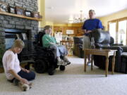 This undated photo shows Terry Horgan with his parents in the family's Montour Falls, N.Y., home. Horgan, a 27-year-old who had Duchenne muscular dystrophy, died last month, Oct. 2022,  according to Cure Rare Disease, a Connecticut-based nonprofit founded by his brother, Rich, to try and save him. Although it's still unclear what killed him, his death is raising questions about the experiment and the overall prospect of what one ethicist calls designer genetic therapies.