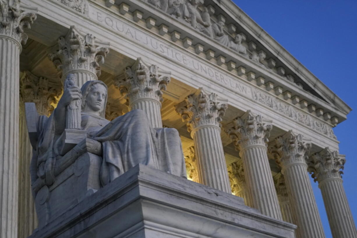 Light illuminates part of the Supreme Court building on Capitol Hill in Washington, Wednesday, Nov. 16, 2022.