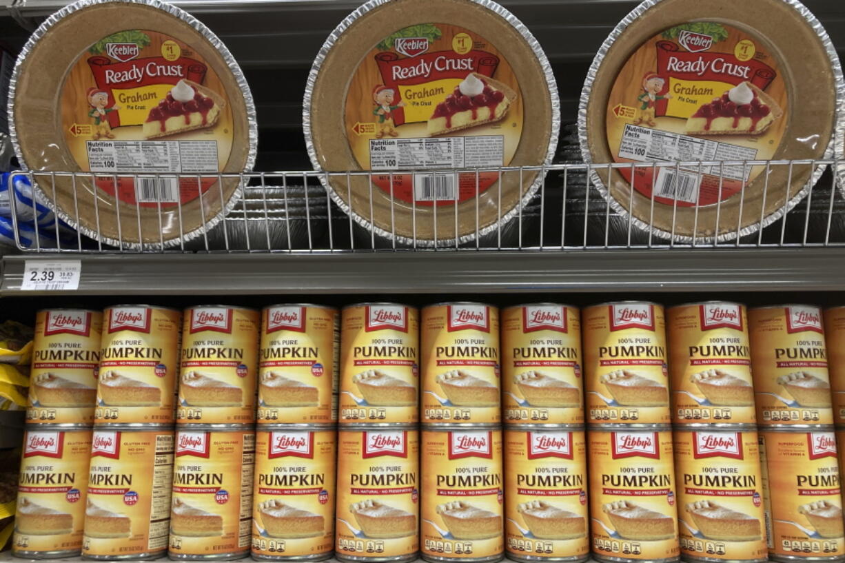 File - Canned pumpkin and graham cracker shell crusts are displayed at a Publix Supermarket, Tuesday, Nov. 16, 2021 in North Miami, Fla. Americans are bracing for a costly Thanksgiving this year, with double-digit percent increases in the price of turkey, potatoes, stuffing, canned pumpkin and other staples.