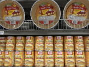 File - Canned pumpkin and graham cracker shell crusts are displayed at a Publix Supermarket, Tuesday, Nov. 16, 2021 in North Miami, Fla. Americans are bracing for a costly Thanksgiving this year, with double-digit percent increases in the price of turkey, potatoes, stuffing, canned pumpkin and other staples.