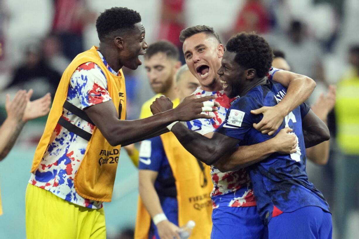 United States' Yunus Musah, right, Aaron Long, center, and United States' goalkeeper Sean Johnson celebrate after defeating Iran in the World Cup group B soccer match between Iran and the United States at the Al Thumama Stadium in Doha, Qatar, Tuesday, Nov. 29, 2022.