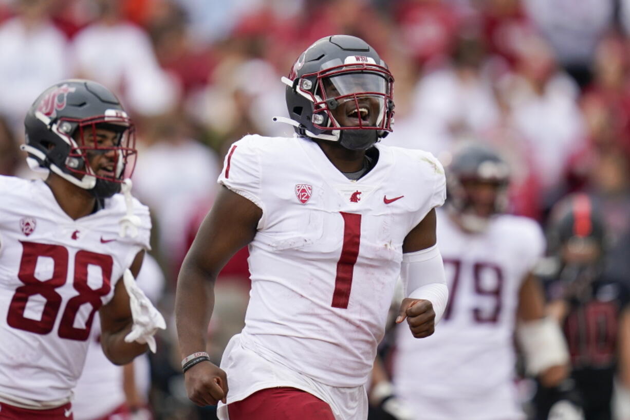 Washington State quarterback Cameron Ward (1) celebrates after throwing a touchdown against Stanford during the first half of an NCAA college football game in Stanford, Calif., Saturday, Nov. 5, 2022. (AP Photo/Godofredo A.