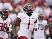 Washington State quarterback Cameron Ward (1) celebrates after throwing a touchdown against Stanford during the first half of an NCAA college football game in Stanford, Calif., Saturday, Nov. 5, 2022. (AP Photo/Godofredo A.