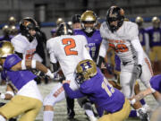 Washougal's Liam Atkin (2) is tackled by Highline's Quentin Camp during Highline's 30-27 win in a 2A state playoff game in Burien on Friday, Nov. 11, 2022.