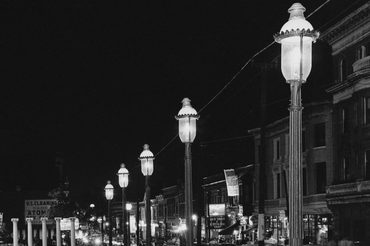 FILE - Gas lamps illuminate St. Louis' Gaslight Square on April 2, 1962. "Gaslighting" -- mind manipulating, grossly misleading, downright deceitful -- is Merriam-Webster's word of 2022.