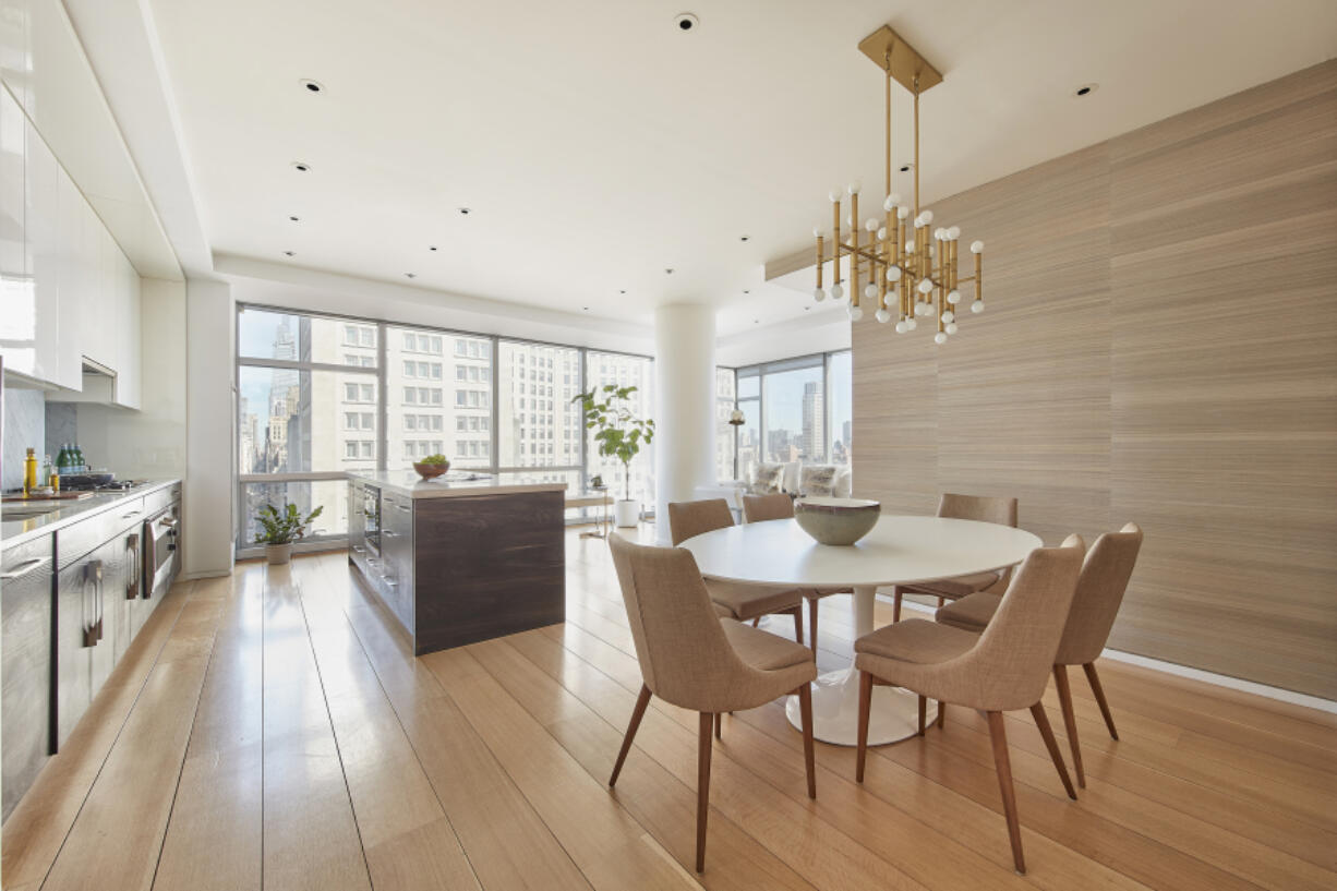 Grass cloth wallpaper adds a sense of formality and elegance to this dining space.