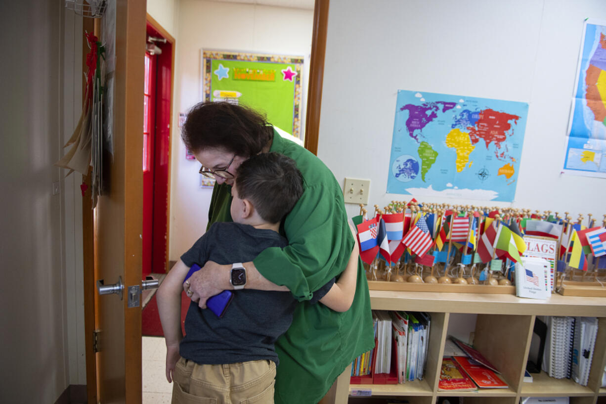 Nikki Skinner, founder of Skinner Montessori School and classroom teacher, shares a kind moment with student Callem Lorenzo, 8, during a break from class. Vancouver's Skinner Montessori School is celebrating its 50th anniversary next year.