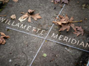 Leaves surround a line designating the Willamette Meridian. All of Oregon and Washington were surveyed from this Initial Point along the Willamette Meridian, which runs north to Canada and south to the California border. The Willamette Baseline runs east-west from the Pacific Ocean to Idaho.