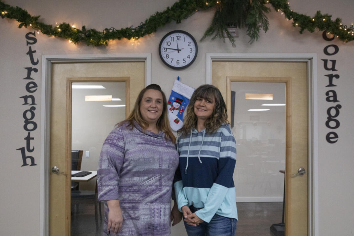 Rachel Grant, left, a family navigator, and Rebecca Greiner, a senior family navigator, pose for a portrait at Recovery Caf? of Clark County.