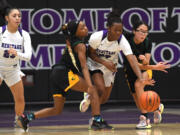 Heritage freshman Jaila Ellis, center, splits two Evergreen defenders Friday, Dec. 9, 2022, during the T-Wolves’ 64-55 loss to Evergreen at Heritage High School.