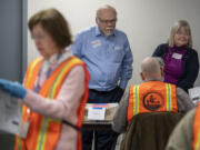 Don Benton joins District 5 County Councilor Sue Marshall at the Clark County Elections Office on Friday to look over results from the manual recount of 12 precincts requested by Benton.