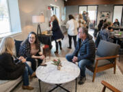 Shelly Austin, from left, chats with her daughter, Catholic Community Services Family Behavioral Health employee Sarah Larkins, and Jeff Austin at the grand opening celebration for Catholic Community Services Family Behavioral Health's new offices in Salmon Creek.