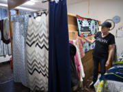 Toni Lindsay, a client at Share's Women's Housing and Transition (WHAT) shelter, holds a sign that says "Believe in Yourself" in her room that she shares with two other women at St. Luke's Episcopal Church. The WHAT shelter used Vancouver's Affordable Housing Fund to stay open around the clock beginning in spring 2020, a time when many shelter residents had nowhere else to go during the day due to the start of the COVID-19 pandemic.