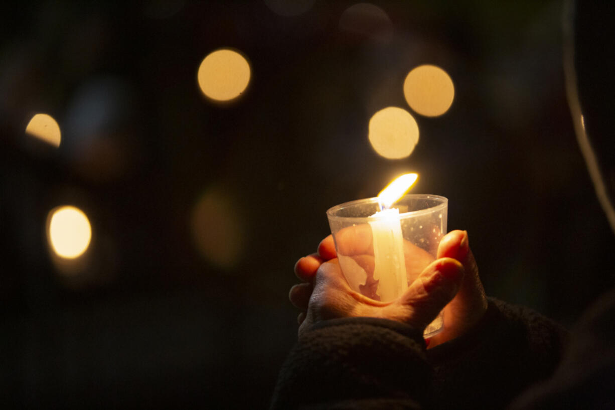 A person holds a lit candle during the annual Homeless Persons' Memorial Day on Wednesday at St. Paul Lutheran Church honoring members and supporters of Clark County's homeless community who died in 2022.