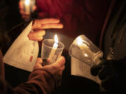 ELAYNA YUSSEN for The Columbian
Attendees light candles at the annual Homeless Persons Memorial Day on Dec. 21 in Vancouver. Homelessness is a persistent top story in Clark County.