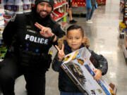 On Dec. 3, 10 Battle Ground police officers accompanied 19 local children on a shopping spree as they bought gifts for their loved ones and items for themselves.