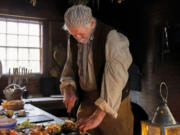 Bob Prinz of Vancouver prepares an 1840s-inspired Christmas dinner. Prinz and fellow volunteers prepared seven courses for the Fort Vancouver meal.