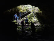 Hikers walk near the entrance of Ape Caves in Gifford Pinchot National Forest on July 22. The caves were discovered in 1942 and are lava tubes from an eruption of Mount St. Helens 2,000 years ago. Temperatures in the caves are 42 degrees year-round.