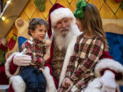 Santa Claus, center, listens to what Luciana, 6, right, and Roman Sereno, 4, both of Battle Ground, want for Christmas at the Vancouver Mall. Legos have been a popular ask from children this year, along with Barbies, Nintendo Switches and the occasional yo-yo.