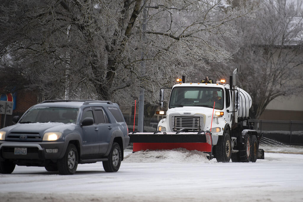 A snowplow tackles frozen roads in east Vancouver on Friday morning, Dec. 23, 2022.