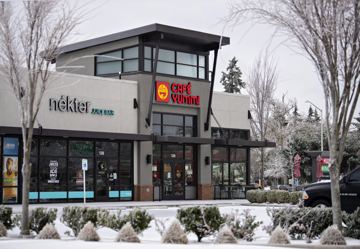 Ice-covered trees frame businesses closed temporarily due to inclement weather Friday in east Vancouver. "It's definitely an interruption to everyday business," said Jason Fish, co-owner of Main Event Sports Grill and Piehole Pizza in Vancouver and 3 Sheets at the Harbor in Portland.