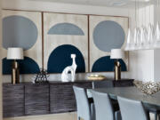 Three pieces of art hung in a series helps add rhythm to this dining room area.