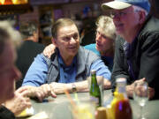 Customer Gayla Golden-Bean gives Chuck Chronis a hug on the final night of business for Chronis' Restaurant and Lounge in April 2015. Chronis died Dec. 4 at 83 years of age.