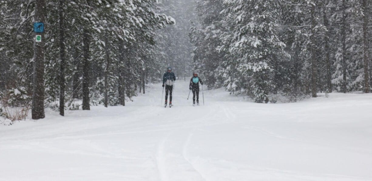 From left, Casey and Leigh Curran cross-country ski at Meissner Sno-park west of Bend, Ore.