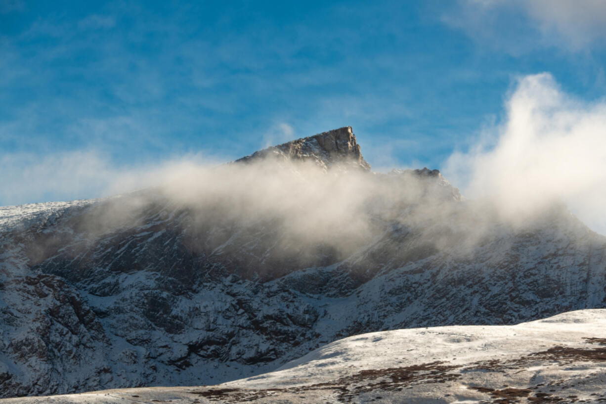 A snowy mountain peak in a windy winter day in Colorado.