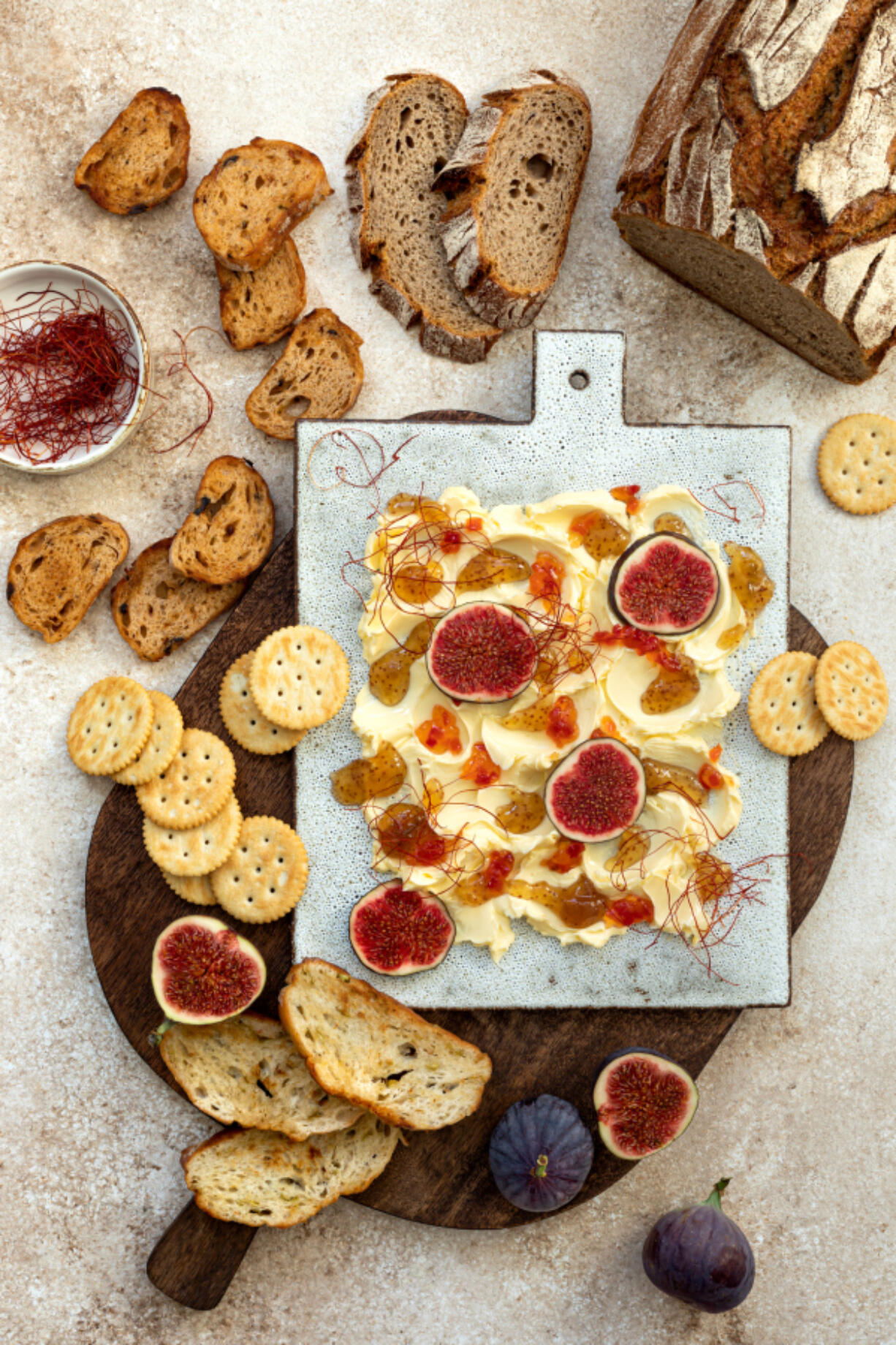 Butter board topped with fresh figs, fig jam, spicy paprika jelly and chili threads.