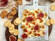 Butter board topped with fresh figs, fig jam, spicy paprika jelly and chili threads.