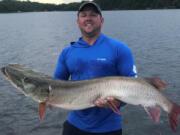 Corey Kitzmann of Davenport, Iowa, owns the new Minnesota muskie release record. He caught this 57 1/4 inch fish while on Lake Vermilion on Aug. 6, 2019.