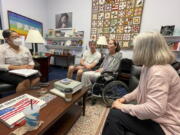 In this photo provided by Becky Mourey, Becky Mourey, center, and her husband Jim, left, meet with representatives for Illinois Rep. Jan Schakowsky at her offices on Capitol Hill, Washington DC in May 2022. Mourey and other ALS patients spent more than two years advocating for the approval of the new drug, Relyvrio, a treatment for ALS. Patients say they are now facing insurance and financial hurdles to access the drug, which costs $158,000.