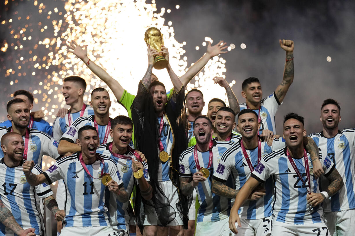 Argentina's Lionel Messi lifts the trophy after winning the World Cup final soccer match between Argentina and France at the Lusail Stadium in Lusail, Qatar, Sunday, Dec. 18, 2022. Argentina won 4-2 in a penalty shootout after the match ended tied 3-3.