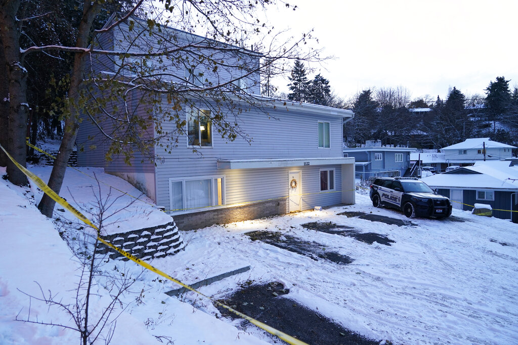 FILE - Bare spots are seen on Nov. 29, 2022, in the snowy parking lot in front of the home where four University of Idaho students were found dead on Nov. 13, in Moscow, Idaho, after vehicles belonging to the victims and others were towed away earlier in the day. Idaho Police investigating the stabbing deaths of the students say they're working with law enforcement in Eugene, Ore., to determine if a white sedan found on the side of the road there is related to the Idaho case. (AP Photo/Ted S.