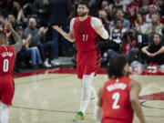 Portland Trail Blazers center Jusuf Nurkic (27) gestures after making a 3-point basket against the Charlotte Hornets during the second half of an NBA basketball game in Portland, Ore., Monday, Dec. 26, 2022.