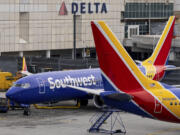 Southwest Airlines' aircrafts parked on the tarmac of LaGuardia Airport, Tuesday, Dec. 27, 2022, in New York. The U.S. Department of Transportation says it will look into flight cancellations by Southwest Airlines that have left travelers stranded at airports across the country amid an intense winter storm.