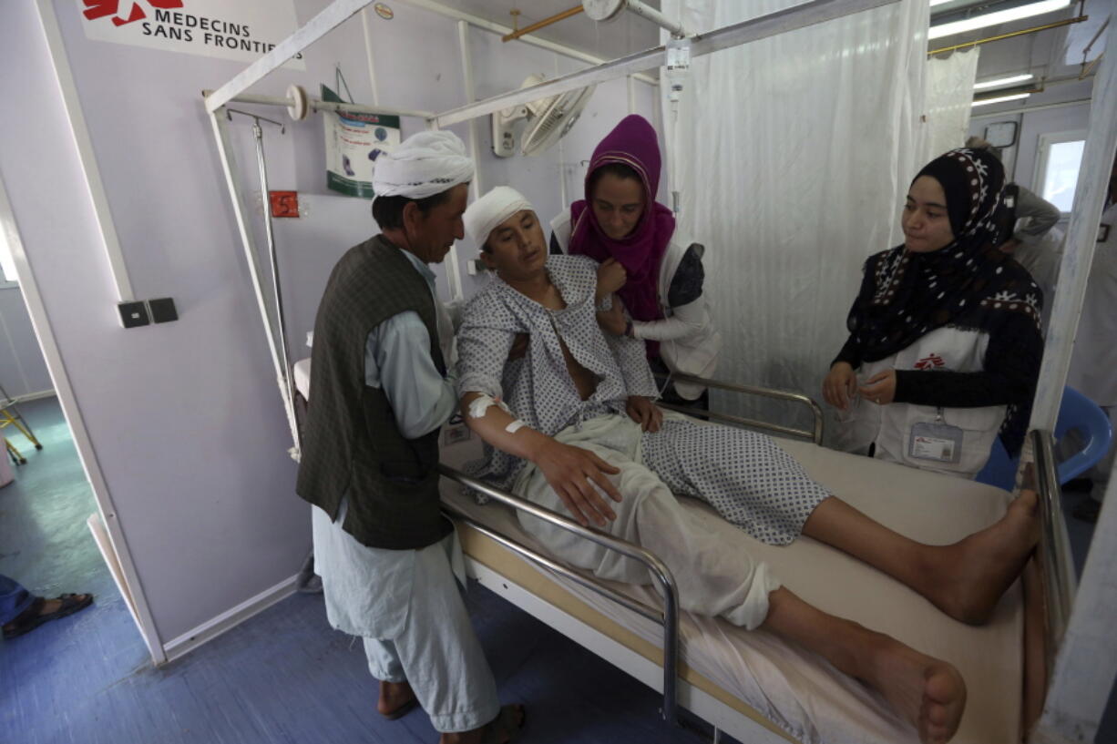 File - In this Wednesday, May 20, 2015 photo an Afghan boy recovers at a Medecins Sans Frontieres hospital in Kunduz province, north of Kabul, Afghanistan. On Saturday, Dec. 26, 2022, Taliban authorities announced the exclusion of women from NGOs, allegedly because they weren't wearing the headscarf, or hijab, correctly. The move prompted international aid agencies to halt operations in Afghanistan, raising the possibility that millions of people will be left without food, education, health care and other critical services during the harsh winter months.