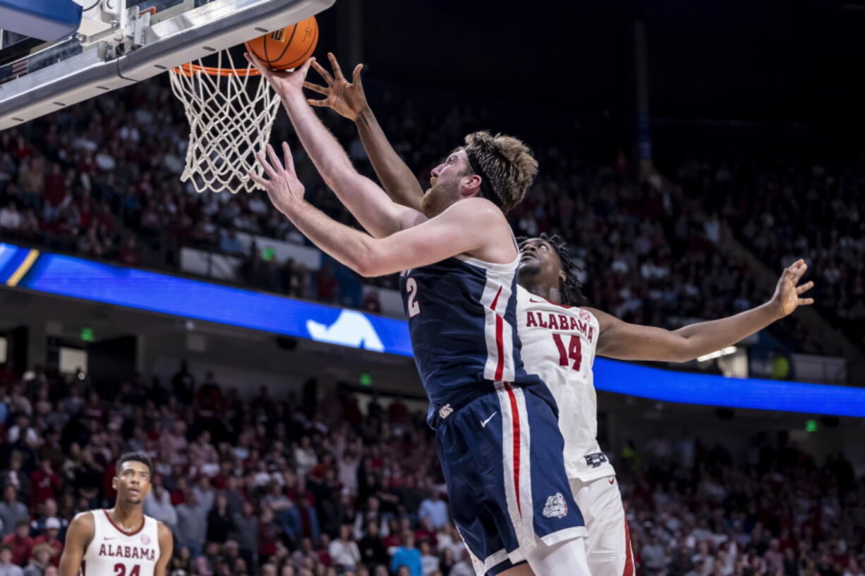 Gonzaga forward Drew Timme (2) gets past Alabama center Charles Bediako (14) for a basket during the second half of an NCAA college basketball game, Saturday, Dec. 17, 2022, in Birmingham, Ala.