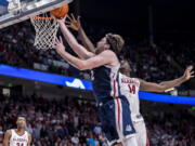 Gonzaga forward Drew Timme (2) gets past Alabama center Charles Bediako (14) for a basket during the second half of an NCAA college basketball game, Saturday, Dec. 17, 2022, in Birmingham, Ala.