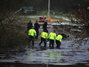 Police search teams at the scene after children fell through ice,in Babbs Mill Park in Kingshurst, Solihull, England, Monday, Dec. 12, 2022. Three young boys who fell through ice covering a lake in central England have died and a fourth remains hospitalized as weather forecasters issued severe weather warnings for large parts of the United Kingdom. Rescuers pulled the boys, aged 8, 10 and 11, from the icy waters Sunday afternoon and rushed them to the hospital in the West Midlands, about 100 miles (160 kilometers) north of London. But they could not be revived after suffering cardiac arrest.