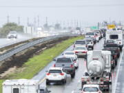 Cars are stopped in the northbound lanes of Highway 101 after flooding closed the highway near Chualar, Calif., Tuesday, Dec. 27, 2022.